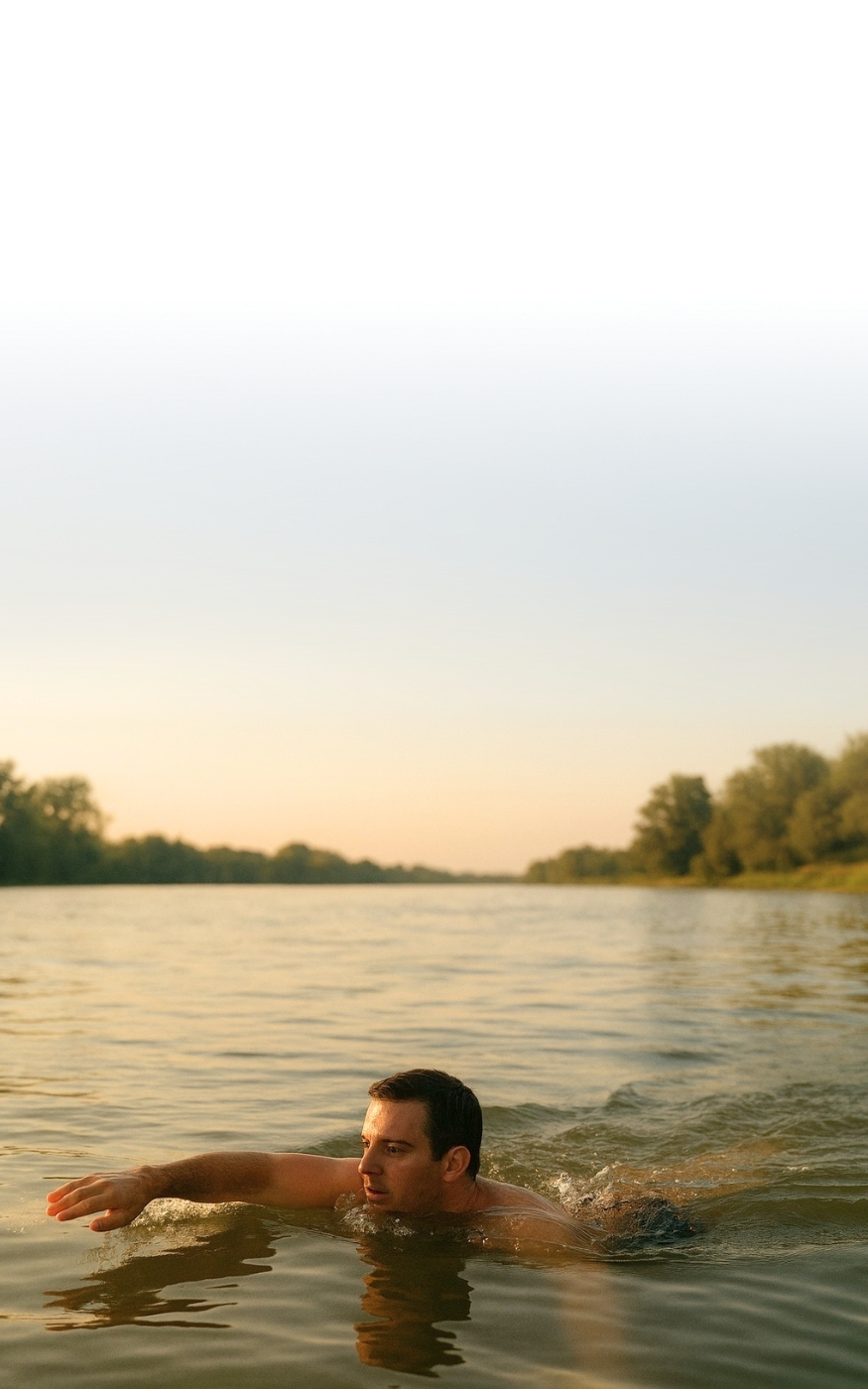 man swimming in a river